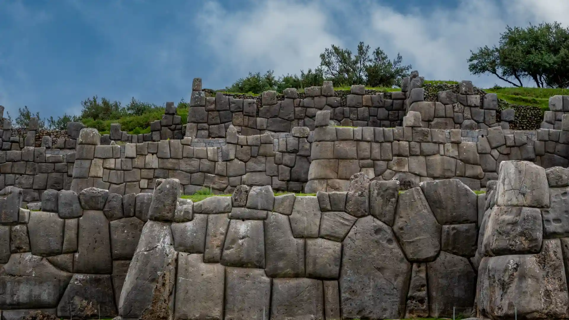 Enormes bloques de piedra perfectamente ensamblados en la fortaleza de Sacsayhuamán. city tour cusco tarde